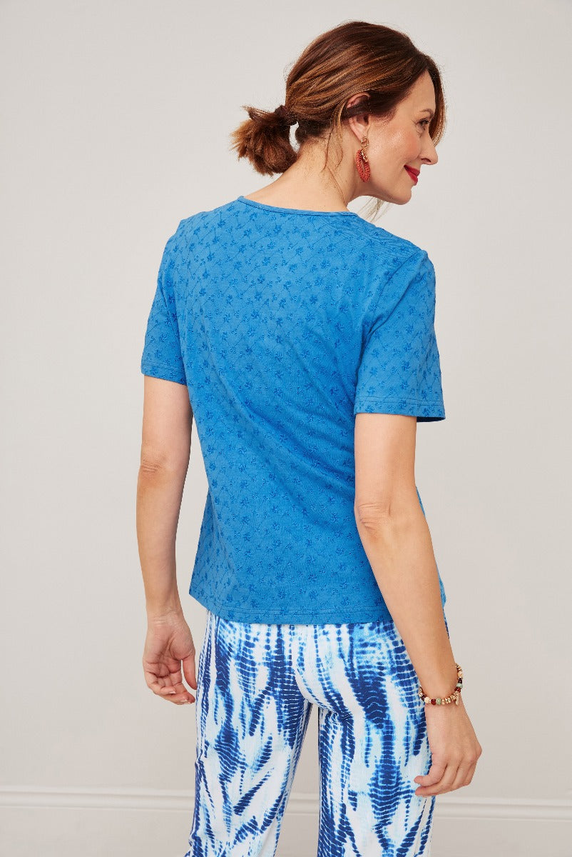 Lily Ella Collection blue floral patterned short-sleeve top and blue white tie-dye print trousers, stylish women's fashion, back view.