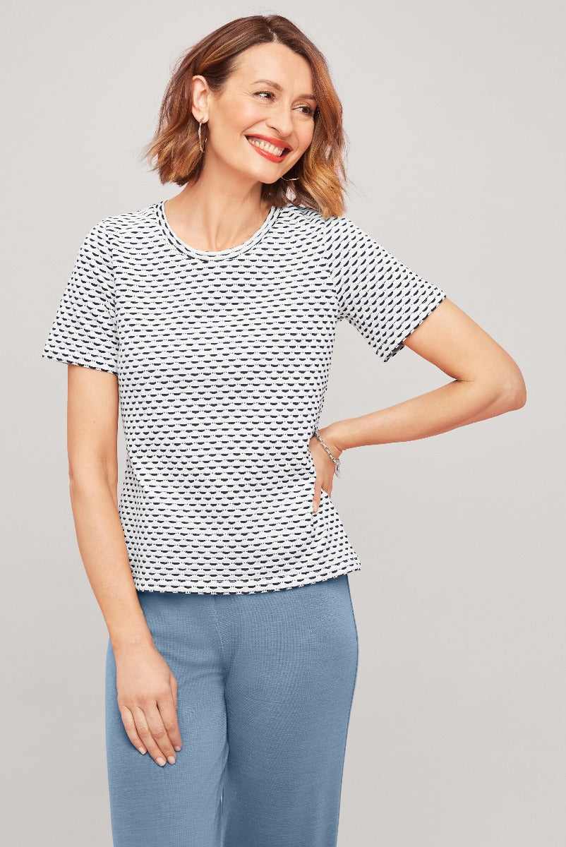 Lily Ella Collection classic white and black patterned women's tee paired with light blue trousers, casual and elegant daytime look