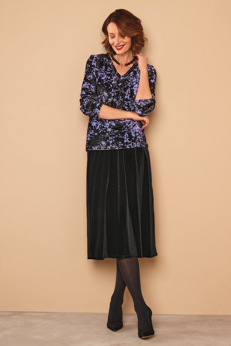 Lily Ella Collection elegant navy blue floral blouse paired with black velvet midi skirt on model for stylish women's fashion.