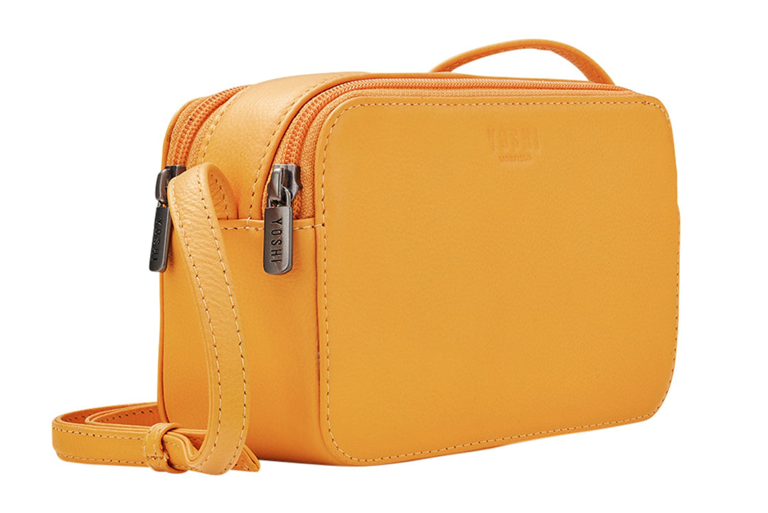 Lily Ella Collection mustard yellow crossbody bag with zipper detail and adjustable strap.